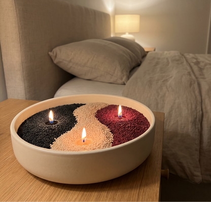 All three scents in one bowl — black, beige and wine-red sand wax pearls with three wicks lit