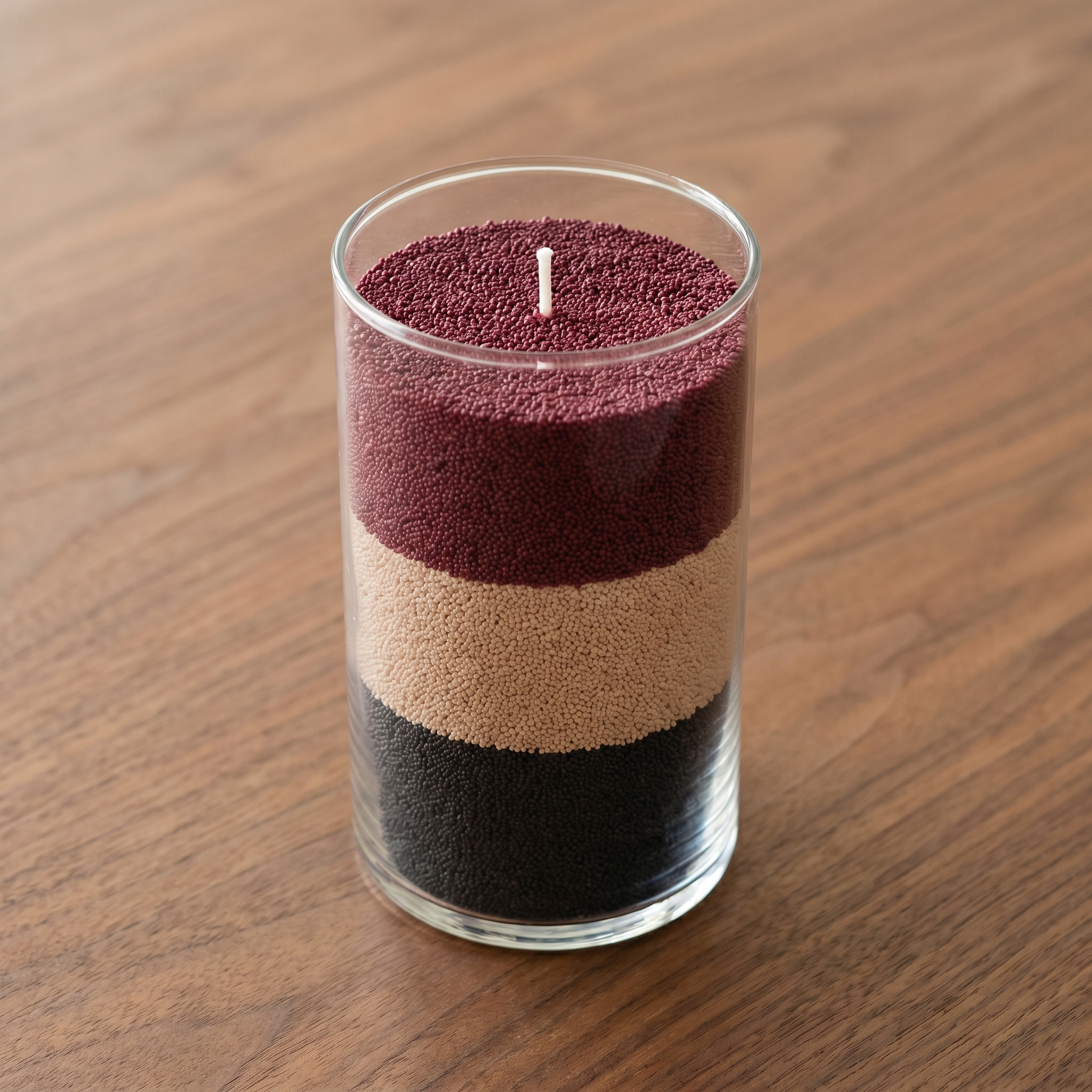 The Scent Stack three colours of sand wax layered in a glass cylinder